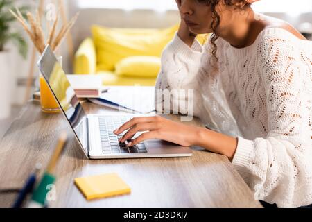 cropped view of displeased woman using laptop at home Stock Photo