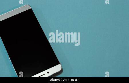 Smart phone on blue background copy space Stock Photo