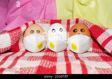 Concept of friendship. Funny three eggs in different colors together. Photo for your design. Eggs on a white-red checkered towel Stock Photo