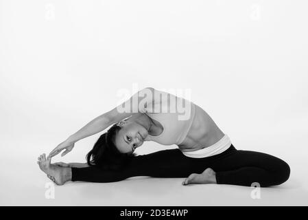 Premium Photo  Fit woman stretching reaching toes sitting on yoga mat  after intense workout in home with dumbbells training
