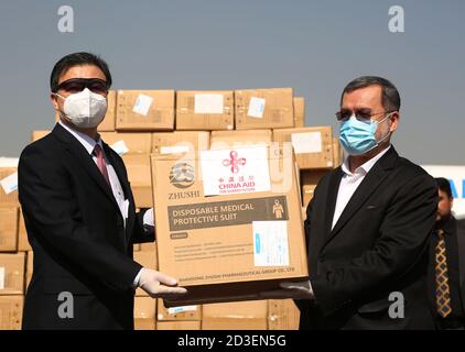 (201008) -- KABUL, Oct. 8, 2020 (Xinhua) -- Sarwar Danish (R), Afghanistan's second vice president, receives the medical supplies from Chinese Ambassador to Afghanistan Wang Yu during the handover ceremony in Kabul,capital of Afghanistan, Oct. 8, 2020. Afghanistan on Thursday received more anti-epidemic supplies from China to aid its fight against COVID-19. They were in the sixth batch of Chinese aid to the war-torn Asian country which was hit by the outbreak of COVID-19 in late February. (Photo by Rahmatullah Alizadah/Xinhua) Stock Photo