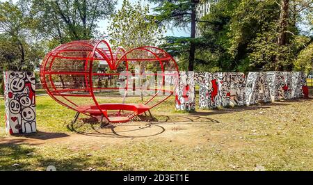 Inscription 'I love Tirana' consisting from heart-shaped bench and letters in public park of Tirana, Albania. Stock Photo