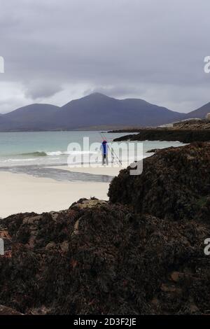 Man fishing at Luskentyre Beach on the west coast of The Isle of Harris, Scotland. Stock Photo