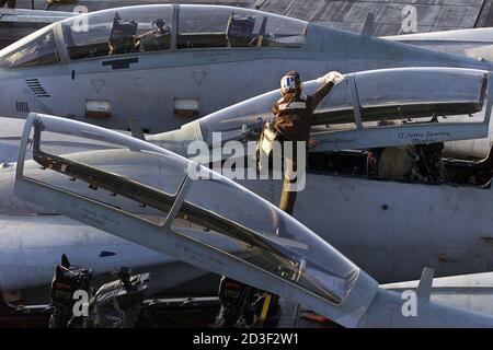 A Plane Captain Cleans The Cockpit Of One Of The F 14 Tomcat Jet Fighters Arrangeed