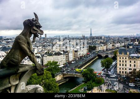 Mythical creature gargoyle on cathedral Notre Dame de Paris. Cityscape of Paris. France. Stock Photo