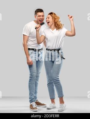 happy couple singing to hairbrush Stock Photo