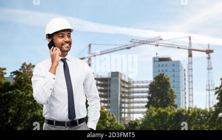 architect calls on smartphone at construction site Stock Photo