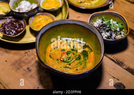 Chicken coconut soup Tom Kha Gai , Thai food on a wooden table, close up shot. Stock Photo