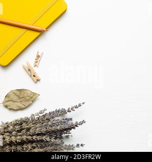 Diary note and pencil with dry lavender on white background. flat lay, top view, copy space Stock Photo