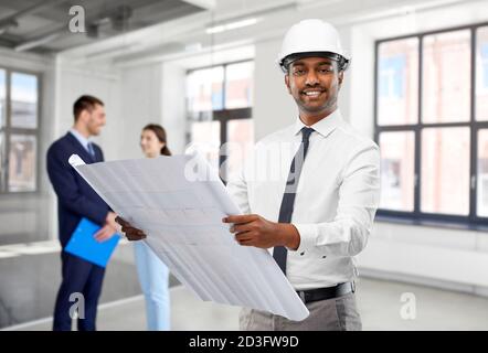 indian male architect with blueprint at office Stock Photo