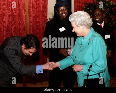 Britain's Queen Elizabeth II meets singer Jools Holland during a reception hosted by the Queen at Buckingham Palace in London.  Britain's Queen Elizabeth II meets British musician Jools Holland (L) during a reception hosted by the Queen at Buckingham Palace in London March 1, 2005. The all-star gathering was royal tribute to Britain's music industry. REUTERS/Kirsty Wigglesworth/PA/WPA Rota