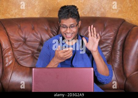 happy young man In a video conference discussing on smart phone  Stock Photo