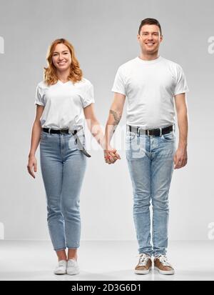 happy couple in white t-shirts holding hands Stock Photo
