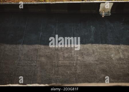 Bitumen roof on an industrial hall combined with tin attic Stock Photo
