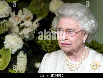 Britain's Queen Elizabeth II examines exhibits during her visit to the Royal Horticultural Society's Chelsea Flower Show in London May 19, 2003.  Thousands of visitors are expected to attend the 81st annual show, organised by the Royal Horticultural Society and held at the Royal Hospital in Chelsea, west London.