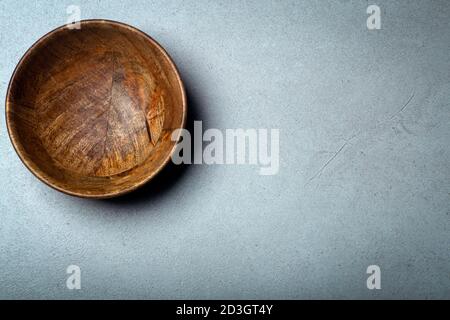 Wooden bowl on a concrete stone surface. Texture and texture of wood and concrete. Stock Photo