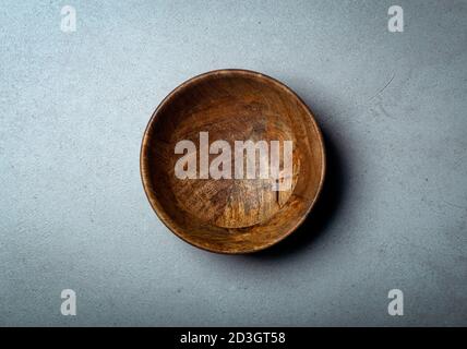 Wooden bowl on a concrete stone surface. Texture and texture of wood and concrete. Stock Photo