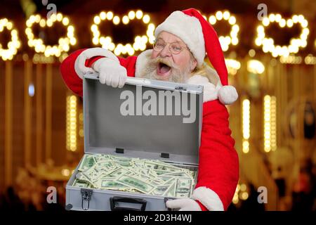 Santa Claus with case full of cash. Stock Photo
