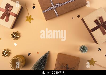 Three Christmas gift boxes on a neutral background among decorations Stock Photo