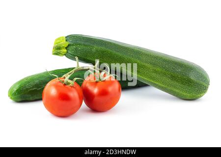 Green cucumber, green zucchini and two red tomatos isolated on a white background. Healthy food. Stock Photo