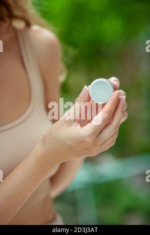 Close up of womns hands holding lip balm Stock Photo