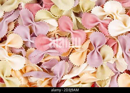 A background of Dry Farfalle pasta AKA butterfly or bow tie pasta with copy space Stock Photo