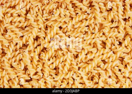 Close up of dry uncooked delicious Fusilli pasta with copy space Stock Photo
