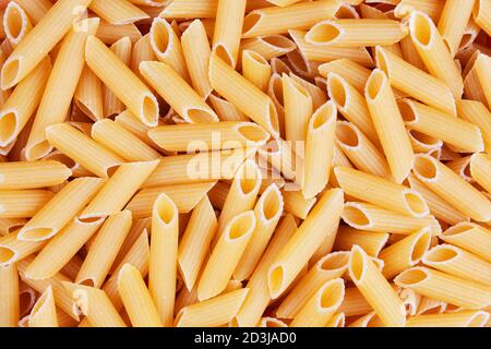 Close up of dry uncooked delicious Penne pasta with copy space Stock Photo