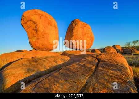Popular and iconic Devils Marbles: Eggs of mythical Rainbow Serpent at sunset. Karlu Karlu - Devils Marbles is one of Australia's most famous natural Stock Photo