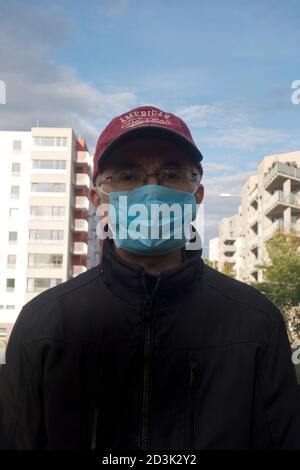 man wearing a protective disposable mask against covid-19 virus Stock Photo