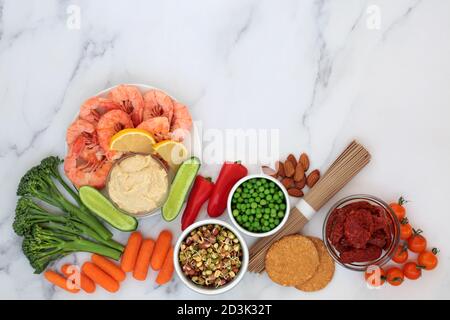 Low glycemic healthy food for diabetics with vegetables, seafood, noodles, dips, cereal & grain products. Below 55 on the GI scale. Stock Photo
