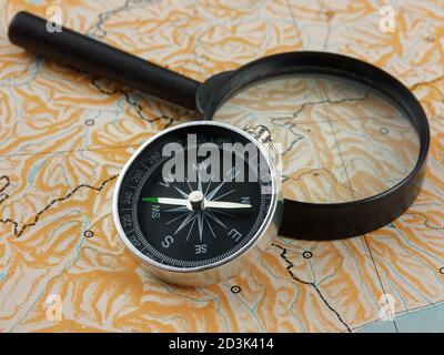 magnifying glass and compass on blank map Stock Photo