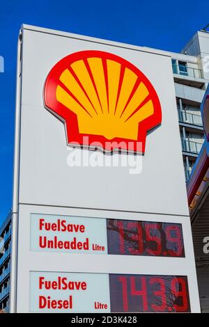 London, UK, February 26, 2012 : Shell logo advertising sign at a retail business service station garage in the city showing its petrol pump price stoc Stock Photo