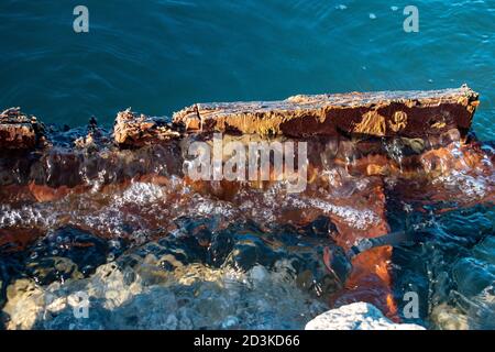 Crystal blue water rising from a submerged piece of wood. Stock Photo