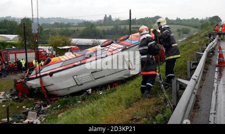 Emergency workers attend the scene of a coach crash, in Dardilly, near Lyon, May 17. At least 28 people were killed and some 40 injured on Saturday when a coach carrying German tourists crashed on a French motorway outside Lyon, French local government officials said. The coach, bound for Spain, was carrying 78 people ranging from teenagers to pensioners who had won the trip in a lottery, when it struck an embankment and overturned in wet conditions.  REUTERS/Robert Pratta