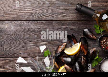 Seafood mussels and white wine on wooden table table. Top view flat lay with copy space Stock Photo
