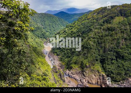 An aerial view of the Barron river in its course between rainforest covered mountains. Stock Photo