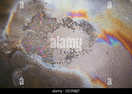 Oil spill on asphalt road background or texture.Environmental pollution concept. Stock Photo