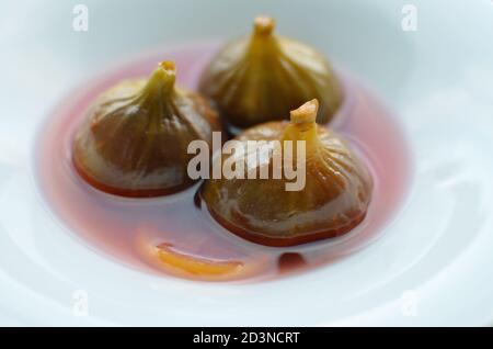 Closeup shot of three figs in syrup dessert Stock Photo