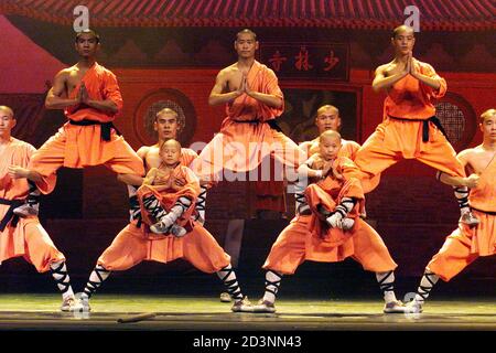 Shaolin monks perform during a stage performance called 'Shaolin Warriors' in Shanghai September 4, 2002. 'Shaolin Warriors' is a choreographed presentation showcasing the Shaolin monks' martial arts and spiritual rituals which includes Buddhist meditation, kung fu exercises, training regime, weapon skills, animal imitation and physical prowess.