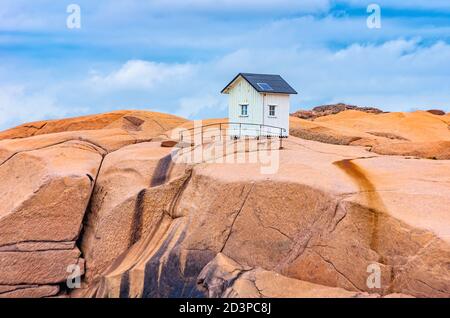 Small wooden hut on a granite rock in the nature reserve (Stangehuvuds nature reserve) off Lysekil, Bohuslan, Vastra Gotaland County, Sweden. Stock Photo