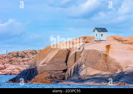 Small wooden hut on a granite rock in the nature reserve (Stangehuvuds nature reserve) off Lysekil, Bohuslan, Vastra Gotaland County, Sweden. Stock Photo