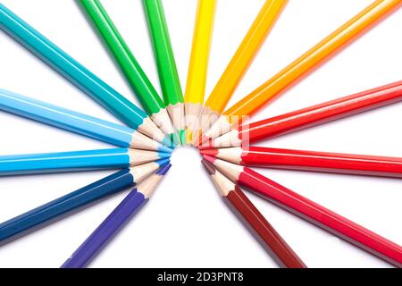 circle or semicircle of colored sharp pencils spouts in the center on a white isolated background Stock Photo