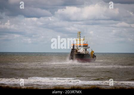 Dredger on the North Sea coast in the Netherlands, province of North Holland Stock Photo