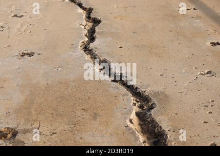 A large crack in concrete. Earthquake concept photo. Stock Photo