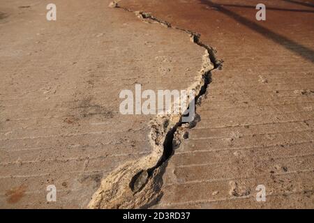 A large crack in concrete. Earthquake concept photo. Stock Photo