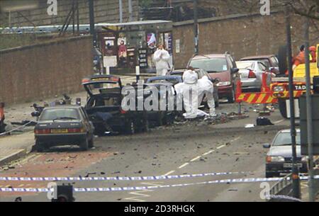 Forensic police officers investigate vehicles March 4, 2001, which were damaged by the car-bomb which exploded outside BBC television studios in west London yesterday evening. British police said on Sunday they suspected a renegade Northern Irish guerrilla group of planting the powerful explosives in the vehicle, which blew up as a bomb disposal unit was carrying out a controlled explosion.  BR