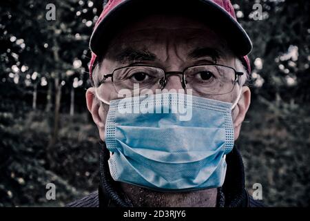 man wearing a protective disposable mask against covid-19 virus Stock Photo
