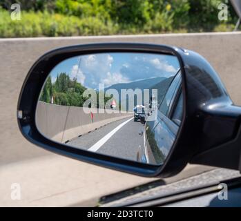 Traffic jam on European highway - lots of cars standing in the queue seen from the rearview mirror Stock Photo
