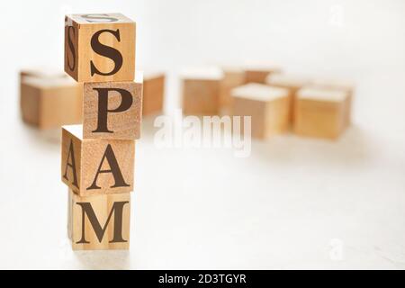 Four wooden cubes arranged in stack with word SPAM on them, space for text / image at down right corner Stock Photo